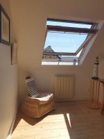 a attic room with a skylight and a bed and a floor at Maison typique bretonne a 5 min de la plage a pied in Crozon