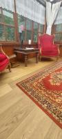 a living room with a red couch and a table at &#39;T boshuisje in Opglabbeek