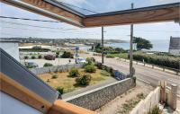 a balcony with a view of a road and the ocean at 2 Bedroom Lovely Home In Plogoff in Plogoff