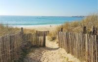 a wooden fence on a beach near the ocean at 2 Bedroom Lovely Home In Plogoff in Plogoff