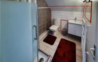 a small bathroom with a toilet and a sink at 2 Bedroom Lovely Home In Plogoff in Plogoff
