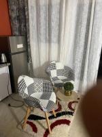 two chairs and a table in front of a window at Pois doux in Fort-de-France