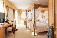 A bed or beds in a room at Wellness Refugium & Resort Hotel Alpin Royal - Small Luxury Hotels of the World