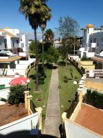 a view from the balcony of a building with palm trees at Apartmento Apartaclub La Barrosa 223 in Chiclana de la Frontera