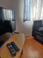 a computer monitor and a remote control sitting on a table at Apartment Nenadic in Hrahorić