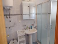 a bathroom with a sink and a shower and a toilet at Apartment Nenadic in Hrahorić