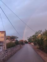 a rainbow in the sky over a road at Apartment Nenadic in Hrahorić