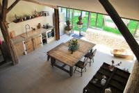 a kitchen with a wooden table in a room at Bassiviere Barn Chic in Saint-Étienne-de-Villeréal