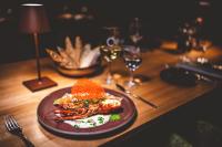 a wooden table with a plate of food on it at Kameha Grand Bonn in Bonn