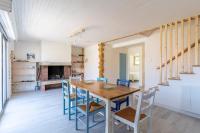 a dining room with a wooden table and chairs at Maison Mimizan plage in Mimizan