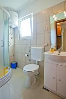 a bathroom with a toilet and a sink at Apartments with a parking space Komiza, Vis - 12325 in Komiža
