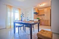 a kitchen with a blue table and chairs in a room at Apartments with a parking space Komiza, Vis - 12325 in Komiža