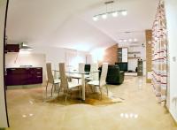 a dining room and kitchen with a table and chairs at Apartments with a parking space Komiza, Vis - 12325 in Komiža