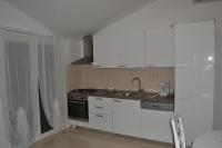 a kitchen with white cabinets and a sink at Apartments with a parking space Grebastica, Sibenik - 13365 in Bašelovići