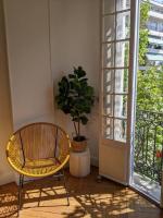 a balcony with a chair and a potted plant at Amazing 2-bedroom apartment in Nice near the beach in Nice
