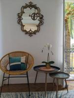 a room with a chair and a table and a mirror at Amazing 2-bedroom apartment in Nice near the beach in Nice