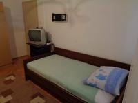 a small bedroom with a bed and a tv at Studio Sukosan 14681b in Sukošan