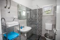 a bathroom with a sink and a shower and a toilet at Apartments with a parking space Sumpetar, Omis - 14941 in Jesenice