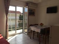 a dining room with a table and a balcony at Apartments with a parking space Orebic, Peljesac - 15086 in Orebić