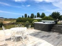 a patio with a table and chairs and a grill at Résidence Le Lenn-louannec - Maisons &amp; Villas pour 6 Personnes 784 in Lannion