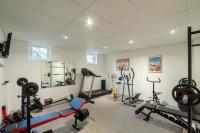 a gym with several exercise equipment in a room at Au Bonheur Caché in Vianne