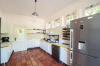 a kitchen with white cabinets and a refrigerator at Au Bonheur Caché in Vianne