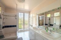 a bathroom with two sinks and a shower at Au Bonheur Caché in Vianne