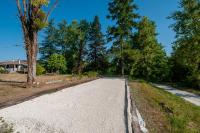 an empty road in a park with trees at Au Bonheur Caché in Vianne