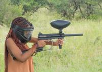 a woman wearing a gas mask holding a gun at Manong Game Lodge in Gaborone