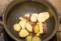 a pot of food with potatoes and meat in it at Manong Game Lodge in Gaborone
