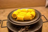 a bunch of corn on a pan on a grill at Manong Game Lodge in Gaborone