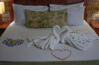 two swans made out of towels on a bed at Manong Game Lodge in Gaborone