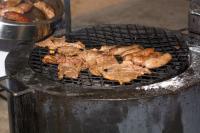 a bunch of food cooking on a grill at Manong Game Lodge in Gaborone