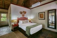a bedroom with a large bed in a room at Manong Game Lodge in Gaborone