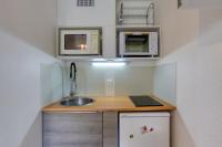 a small kitchen with a sink and microwaves at Soyouz-Vanguard 10 in Villarembert