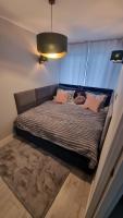Posteľ alebo postele v izbe v ubytovaní Apartament ZACISZE