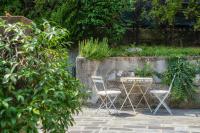 A garden outside I D'A Charming Penthouse - LAKE VIEW- Como- House-130 mt-2 double bedrooms and 2 double bathrooms a spacious living room-Full equipped kitchen-Private garden and terrace-Private covered parking