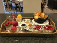 a tray of food on a table with fruit and croissants at Villa Amara in Aix-en-Provence