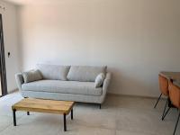 a living room with a couch and a coffee table at Maison neuve avec piscine in Corbara