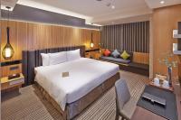 a bedroom with a large bed and a couch at La Vida Hotel in Taichung