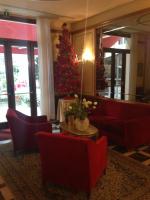 a hotel lobby with a christmas tree and red chairs at Hotel Amadeus in Venice