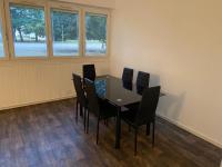 a dining room with a table and chairs at Bel appartement spacieux, lumineux avec parking in Ris-Orangis