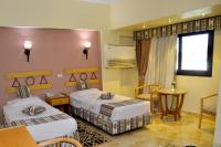 A bed or beds in a room at Marhaba Palace Hotel