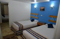 A bed or beds in a room at Marhaba Palace Hotel