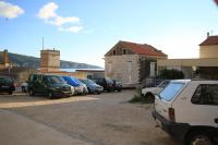 a group of cars parked in a parking lot at Apartments and rooms by the sea Komiza, Vis - 2431 in Komiža