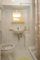 a bathroom with a toilet and a sink and a mirror at Apartments and rooms by the sea Komiza, Vis - 2431 in Komiža