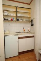 a kitchen with white cabinets and white counters at Apartments and rooms by the sea Komiza, Vis - 2431 in Komiža