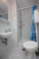 a bathroom with a toilet and a sink and a shower at Apartments and rooms by the sea Komiza, Vis - 2431 in Komiža