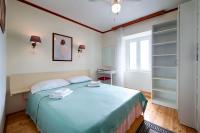 a bedroom with a bed with two towels on it at Apartments and rooms by the sea Komiza, Vis - 2431 in Komiža