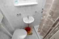 a small bathroom with a toilet and a sink at Apartments and rooms by the sea Komiza, Vis - 2431 in Komiža